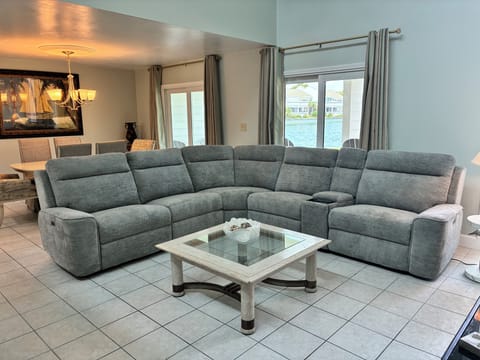 Living Space with Large seating area - A plastic tray and storage in the couch armchair for guest convenience