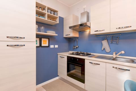 Kitchen equipped with fridge, oven and microwave