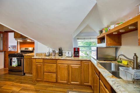 Fully stock kitchen with microwave oven, coffee maker, dishwasher & gas stove