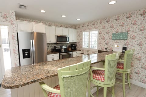 Kitchen with stainless steel appliances and breakfast bar