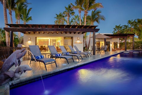 Private patio and pool with lounge chairs. 