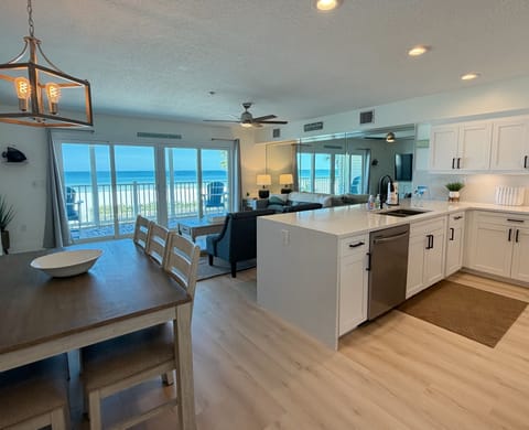 View coming into the main living area of the kitchen, dining roo - View coming into the main living area of the kitchen, dining room, living room all highlighted by a beachfront view of Indian Rocks Beach.