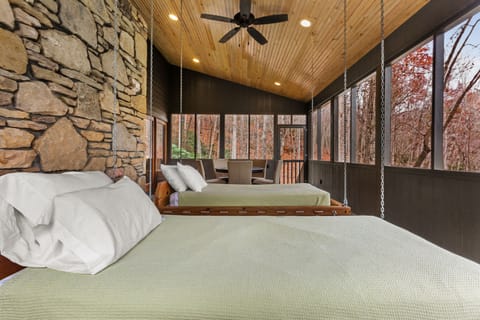 The Huntley features Swinging Beds on a Screened in Porch.