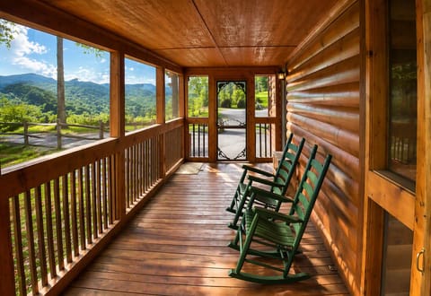 Unwind on the screened‑in porch in the two hunter‑green rockers, an ideal spot for morning coffee or peaceful evenings outdoors