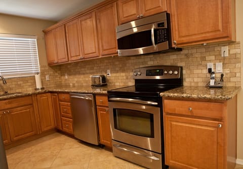 Cherry Cabinets and GE Profile Appliances Throughout The Kitchen.