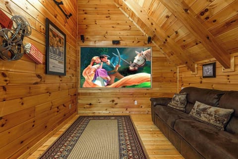 This luxury theater room showcases a breathtaking 96" projection screen with a powerful sound system, creating an immersive, big‑screen cinematic experience right inside the cabin