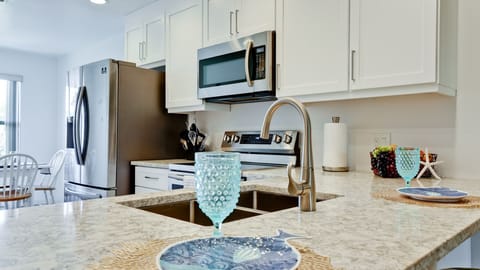 Large kicthen island with bar stools.