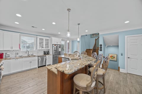 Your gourmet kitchen awaits with granite countertops, stainless appliances, and a breakfast bar perfect for morning coffee chats.