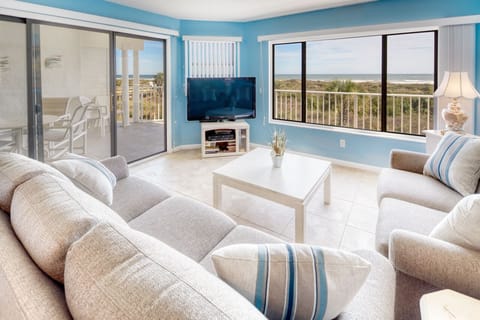 Living Room - View to Porch - Spacious living room with open floor plan and connected balcony featuring a direct view of the ocean.