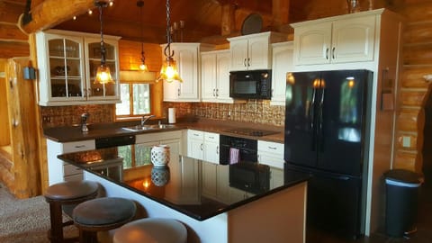 Open kitchen with granite island is perfect for entertaining.