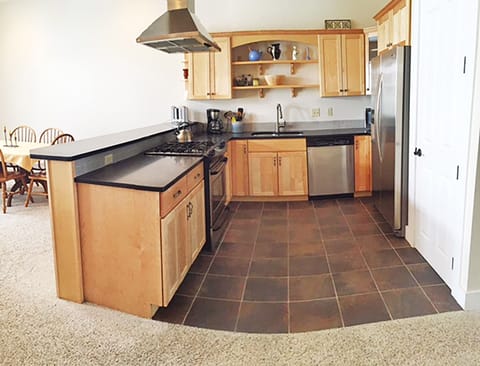 Kitchen is spacious and fully stocked.