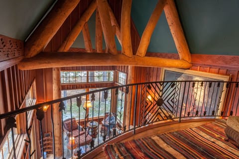 View from the upper floor, showing custom wrought iron and hewn log trusses