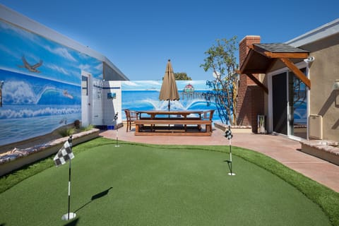 Teak Table is 8 feet and seats 10 with an umbrella. Putting Green