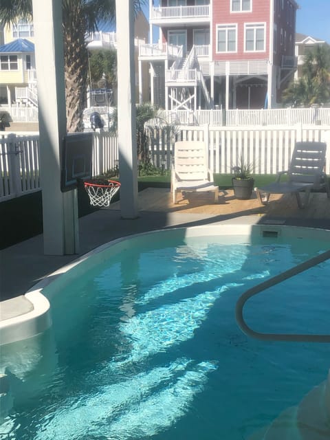 Swimming pool with basketball goal