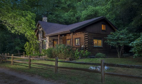 Beautiful log home nestled into a hillside by a picturesque pond. 