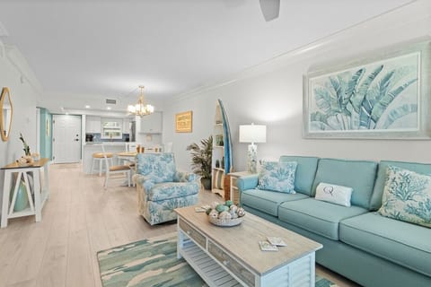 Coastal-inspired living room and dining area with soothing aqua tones, beachy décor, and open-concept design.