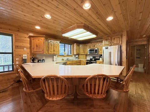 Kitchen located on the main floor. 6 bar stools on the island for additional seating.