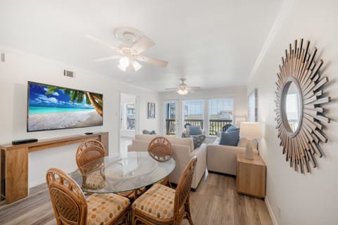 Unwind in your stylish living space with tropical beach vibes on the big screen and comfortable seating for memorable evenings.