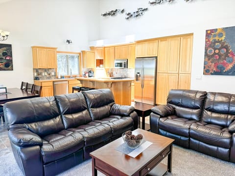 Gather in the open-concept living space, where plush leather seating meets a fully equipped kitchen and dining area. Perfect for enjoying quality time, delicious meals, and the comforts of home