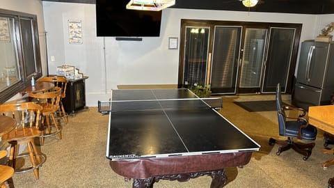 70" NanoCell LED Smart TV & Conversion Ping Pong Table Top in Recreation Room.