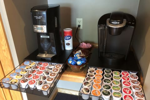 Coffee station with 2 brewers, Keurig pods, and various coffee supplies.