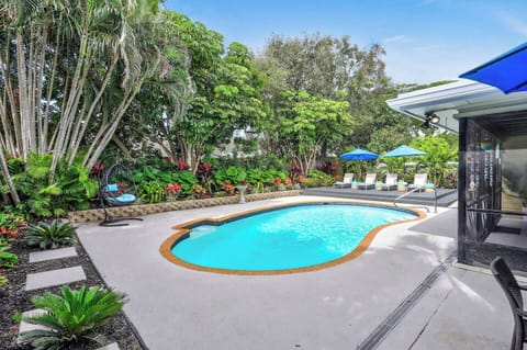 Step into your own private paradise where a crystal-clear, heated pool glistens beneath swaying palms and lush tropical foliage. Secluded from the outside world, this tranquil garden oasis invites you to unwind, recharge, and enjoy an unforgettable e