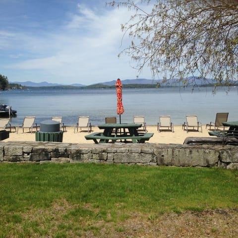 Private beach with chairs, grills, and recreation.