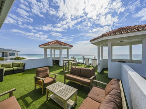 1800 square-foot rooftop balcony with glass rails, artificial turf overlooking the beach