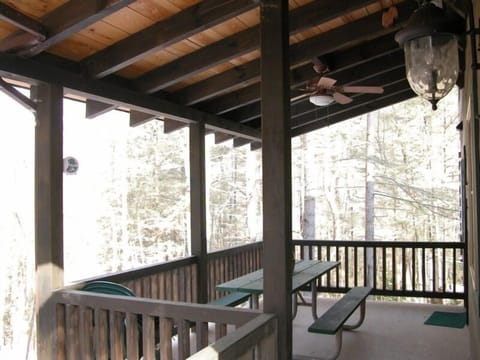 Rear porch with picnic table surrounded by nature