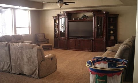 Middle Floor Family Room with 65 inch TV, and air hockey.