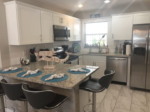 Stylish kitchen fully equipped with plenty storage space. 