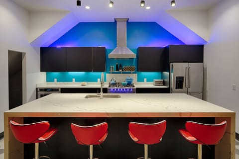 Bar seating and custom kitchen with commercial appliances