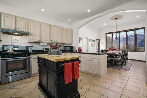 Fully Stocked Kitchen and Dining Room with Bar Seating