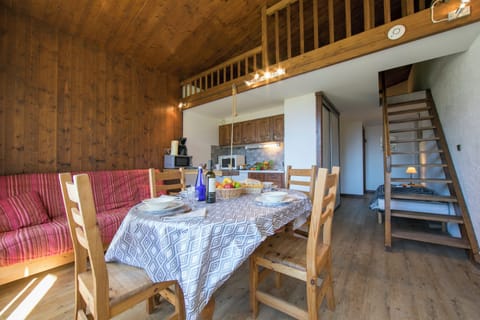 Living room with a dining table and sofa bed