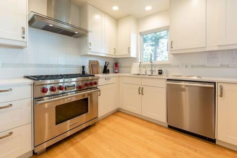 Modern kitchen with Wolf Range & high-end appliances.