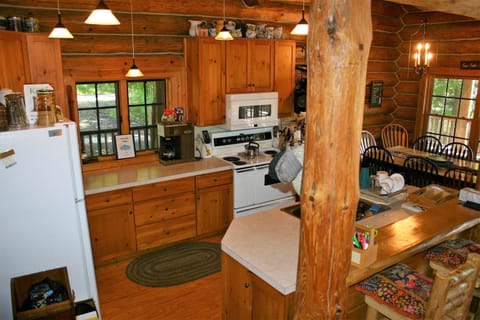 Looking into kitchen area, microwave.  extra fridge in basement