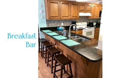 Bar seating and fully furnished kitchen.