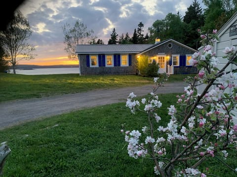 The charming Starfish Cottage overlooking the ocean at sunset!
