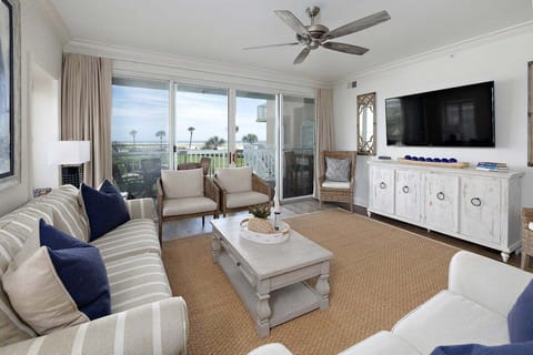 Saint Simons Grand #103 Living Space with Large T.V., Ceiling Fan, Coffee Table, and Patio Access