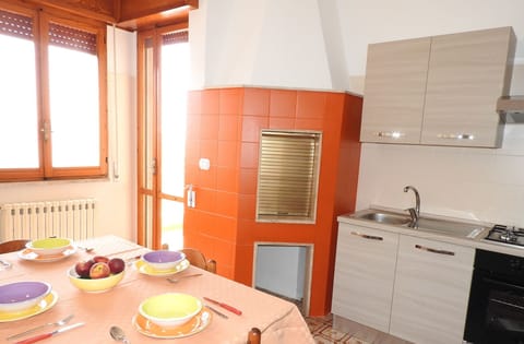 Orange kitchen with traditional oven  