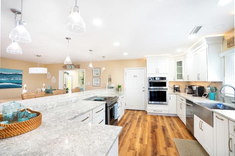 Chef's Kitchen with double ovens, microwave, surface cooktop, wine fridge, and extra large refrigerator!