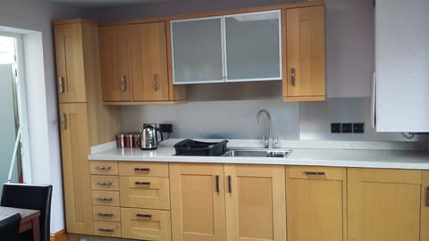 The recently refurbished kitchen has attractive light oak units