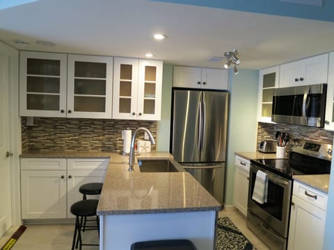 New kitchen with stainless steel appliances.