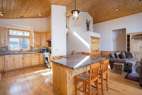 Step into the well-equipped kitchen that offers granite countertop and beautiful pine cabinetry, stainless steel appliances including a large french door refrigerator with bottom freezer, 2 sinks and a breakfast bar with seating for 4.