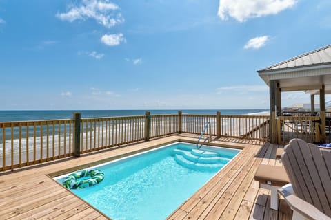 Direct Gulf-front home in Dauphin Island, Alabama featuring a private pool overlooking the beach. Step from the deck to the sand and enjoy unobstructed Gulf Coast views from this beachfront vacation rental.
