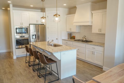 Kitchen - The Kitchen is complete with everything you will need for meal preparations including pots, pans, baking dishes, plates, cups, silverware, cutlery, and an assortment of cooking utensils.