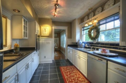 Gorgeous cottage kitchen with garden and bay views through dining room.