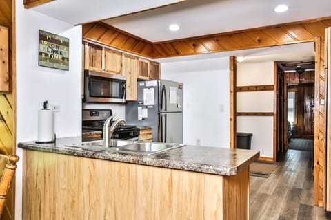 Beautiful granite counter tops and wood paneling along the ceiling