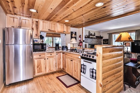Rich wooden cabinetry & ceiling create rustic ambiance.