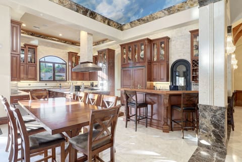 Entertainer's dream! Gourmet kitchen with bar, granite & wine storage.